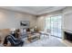 Bright living room with neutral tones, complemented by a modern sofa and a cozy rug at 902 W Glendale Ave # 115, Phoenix, AZ 85021