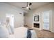 Bright main bedroom featuring a fireplace, an access door to the outside, and a ceiling fan at 902 W Glendale Ave # 115, Phoenix, AZ 85021