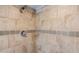 Close-up of a tiled shower with modern fixtures and an interesting tile accent at 902 W Glendale Ave # 115, Phoenix, AZ 85021