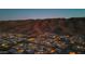 Dusk aerial view of home development with mountain backdrop at 1127 E Mcneil St, Phoenix, AZ 85042