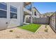 Backyard featuring a small patch of artificial grass and a stone wall at 1127 E Mcneil St, Phoenix, AZ 85042