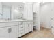 Bathroom featuring double sinks, white cabinets and tile floors at 1127 E Mcneil St, Phoenix, AZ 85042