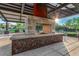 Outdoor fireplace and gathering area with a unique metal design and desert landscaping at 1127 E Mcneil St, Phoenix, AZ 85042