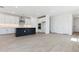Bright open-concept kitchen featuring a large island and sleek, modern cabinetry at 1127 E Mcneil St, Phoenix, AZ 85042