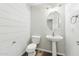 This half bath features a pedestal sink and white shiplap at 1227 W Avalon Canyon Dr, Casa Grande, AZ 85122