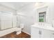 Clean bathroom featuring white vanity, shower over tub, and tile floors at 1227 W Avalon Canyon Dr, Casa Grande, AZ 85122