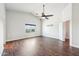 Bright bedroom featuring a ceiling fan, window, and warm wood flooring at 1227 W Avalon Canyon Dr, Casa Grande, AZ 85122