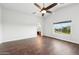 Large bedroom with hard floors, ceiling fan, natural light, and ensuite bath at 1227 W Avalon Canyon Dr, Casa Grande, AZ 85122