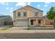 Two-story home showcasing a two-car garage, covered porch, and a neatly maintained front yard at 1227 W Avalon Canyon Dr, Casa Grande, AZ 85122