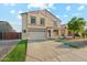 Two-story home features a two-car garage, covered porch, and lush green lawn at 1227 W Avalon Canyon Dr, Casa Grande, AZ 85122