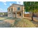 Two-story home with a covered porch, two-car garage, and desert landscaping at 1227 W Avalon Canyon Dr, Casa Grande, AZ 85122