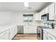 Bright kitchen featuring white cabinets, quartz countertops, and stainless steel appliances at 1227 W Avalon Canyon Dr, Casa Grande, AZ 85122