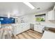 Modern white kitchen featuring an island with seating, stainless steel appliances, and an open floor plan at 1227 W Avalon Canyon Dr, Casa Grande, AZ 85122