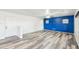 Spacious living room with wood floors, decorative blue wall, and ample natural light at 1227 W Avalon Canyon Dr, Casa Grande, AZ 85122