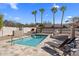 Outdoor oasis with a sparkling pool, desert landscaping, lounge chairs, and custom fireplace at 1327 E Le Marche Ave, Phoenix, AZ 85022