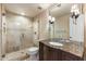 Bathroom featuring a marble vanity, framed mirror, and luxurious walk-in shower at 1327 E Le Marche Ave, Phoenix, AZ 85022