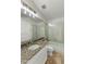 Bright bathroom featuring a large granite vanity, shower-tub combo with glass doors at 1327 E Le Marche Ave, Phoenix, AZ 85022