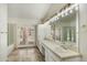 Bathroom with double sinks, large mirrors, ample counter space, and access to the outdoor pool at 1327 E Le Marche Ave, Phoenix, AZ 85022