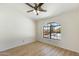 Empty bedroom featuring hardwood floors and an arched window overlooking the neighborhood at 1327 E Le Marche Ave, Phoenix, AZ 85022
