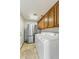 Well-equipped laundry room featuring a refrigerator, washer, dryer and ample storage at 1327 E Le Marche Ave, Phoenix, AZ 85022