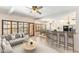 Sun-drenched living area with large windows, neutral decor, breakfast bar and open access to dining room at 1327 E Le Marche Ave, Phoenix, AZ 85022