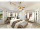 Bright main bedroom with large windows, ceiling fan, and stylish furnishings at 1327 E Le Marche Ave, Phoenix, AZ 85022