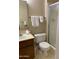 Standard bathroom featuring a toilet, sink, and a shower with glass door at 136 N 63Rd St, Mesa, AZ 85205