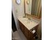 Bathroom featuring a vanity with a sink, a framed mirror, and a toilet paper holder at 136 N 63Rd St, Mesa, AZ 85205