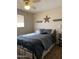 Cozy bedroom with a comfortable bed, decorative wall shelves, and a peaceful ambiance at 136 N 63Rd St, Mesa, AZ 85205