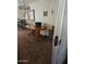 A dining area is adjacent to an interior door and features a wood dining table and chandelier at 136 N 63Rd St, Mesa, AZ 85205