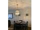 Well-lit dining area showcasing an elegant chandelier and a cozy space for meals at 136 N 63Rd St, Mesa, AZ 85205