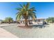 Inviting home with desert landscaping, mature palm trees and a covered parking area at 136 N 63Rd St, Mesa, AZ 85205