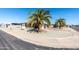 Inviting home with desert landscaping, mature palm trees and a covered parking area at 136 N 63Rd St, Mesa, AZ 85205