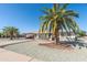 Inviting home with desert landscaping, mature palm trees and a covered parking area at 136 N 63Rd St, Mesa, AZ 85205