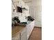 Inside a garage with white cabinets, work lights, and shelving at 136 N 63Rd St, Mesa, AZ 85205