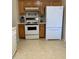 Functional kitchen featuring appliances, wood cabinets, and tile flooring, ready for your personal touch at 136 N 63Rd St, Mesa, AZ 85205
