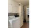 Functional laundry room with washer, dryer, and ample cabinet space at 136 N 63Rd St, Mesa, AZ 85205