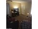 The cozy living room is furnished with a TV, an end table and natural light at 136 N 63Rd St, Mesa, AZ 85205
