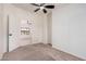 Carpeted bedroom with ceiling fan and desert views at 13802 N 186Th Ave, Surprise, AZ 85388