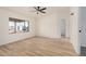 Light bedroom with fan, wood floors, view to back of the property at 13802 N 186Th Ave, Surprise, AZ 85388