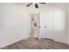 Bright bedroom features neutral carpet, fan, and view to another room at 13802 N 186Th Ave, Surprise, AZ 85388