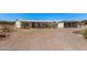 Quaint home with desert landscaping and a covered patio, accompanied by a carport, showcasing a functional and inviting outdoor space at 13802 N 186Th Ave, Surprise, AZ 85388