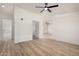 Open floor plan living room with wood-look floors and neutral paint at 13802 N 186Th Ave, Surprise, AZ 85388