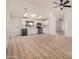 Open floor plan showcasing a bright living area connected to a modern kitchen, all enhanced by stylish hardwood flooring and natural light at 13802 N 186Th Ave, Surprise, AZ 85388