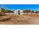 An exterior view of a small shed in the backyard at 13802 N 186Th Ave, Surprise, AZ 85388
