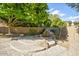 Backyard stone water feature, mature trees and desert landscaping create a peaceful retreat at 1530 E Jeanine Dr, Tempe, AZ 85284