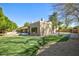 Backyard with putting green, basketball court, mature trees and desert landscaping at 1530 E Jeanine Dr, Tempe, AZ 85284