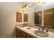 Bathroom featuring double sinks, granite countertops, and a large mirror with sconces at 1530 E Jeanine Dr, Tempe, AZ 85284