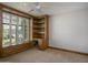 Bedroom with built in shelves and desk with a window and a ceiling fan at 1530 E Jeanine Dr, Tempe, AZ 85284