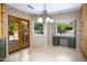 A light-filled dining area with backyard access, built-in desk, and charming floral wallpaper at 1530 E Jeanine Dr, Tempe, AZ 85284